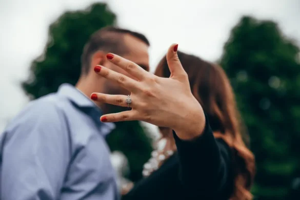 A woman put her hand directly in front the camera to show off her wedding ring.