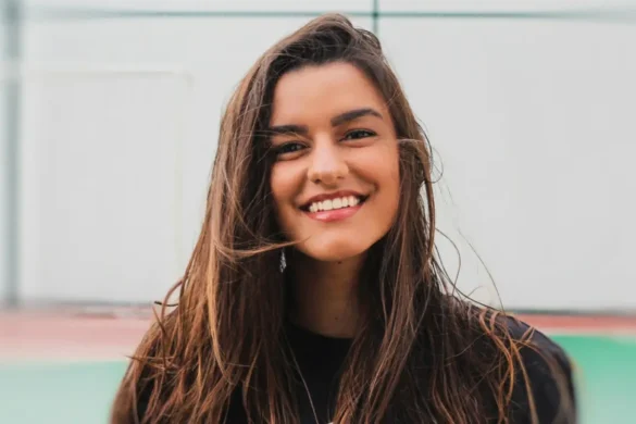 Young woman confidently smiling at camera.