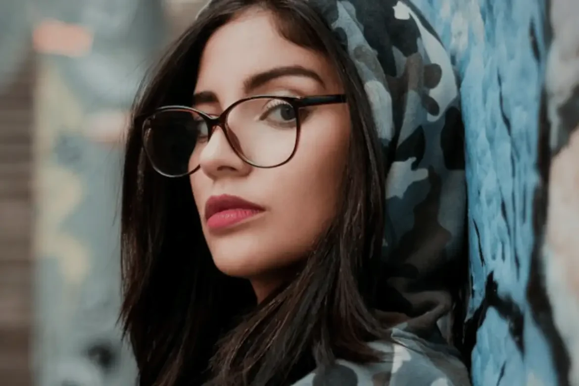 Close up of woman looking into camera with a serious face expression.