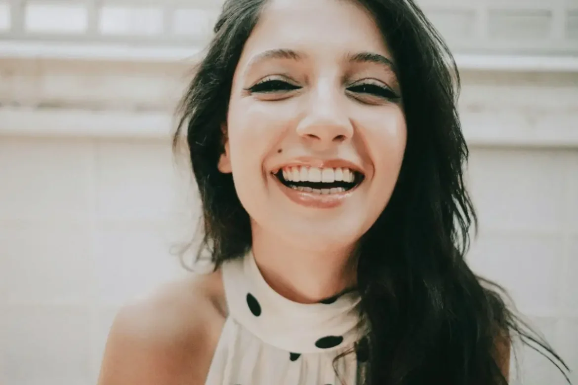 Laughing woman looking at camera.