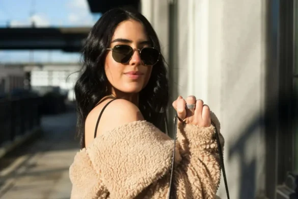 Woman wearing a stylish outfit, striking a flirty pose for the camera.