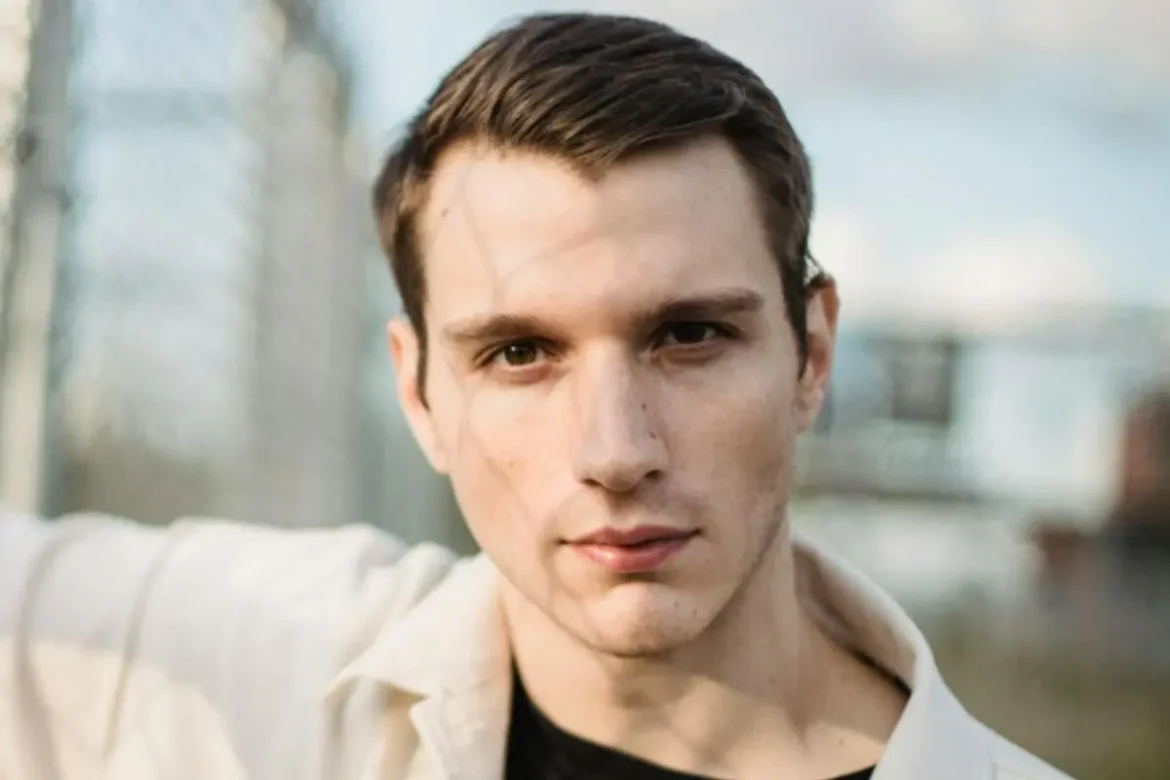 Young man staring into camera with a sinister expression.
