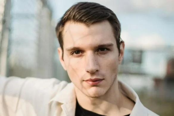 Young man staring into camera with a sinister expression.